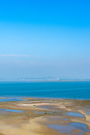 Beautiful seascape with blue sky and sea at low tideの写真素材