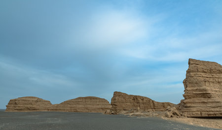 Landscape of rock formations in the desert with blue sky and cloudsの写真素材