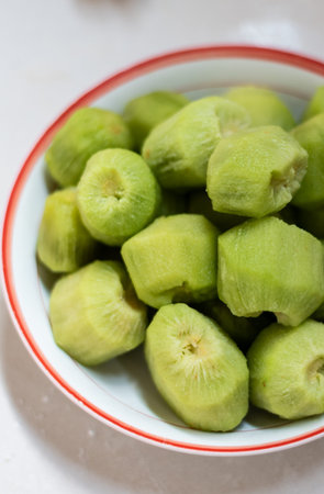 Close up of a bowl of chayote on white background.