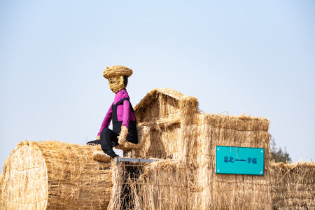 Rural landscape with straw bales and a scarecrow in the countrysideの写真素材