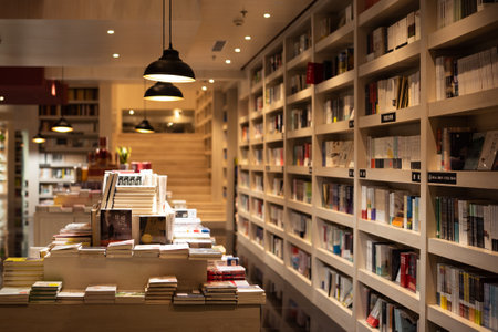 Bookshelf in a library at night with many books on itの写真素材