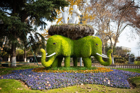Beautiful green elephant made of grass and flowers in the park.の写真素材