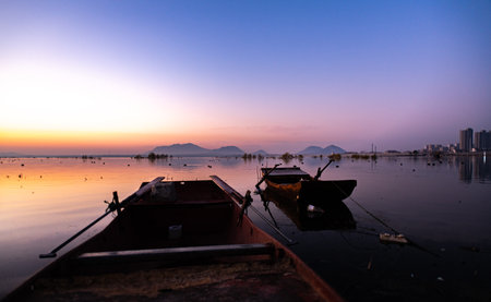 Fishing boat on the lake at sunset, Hangzhou, Chinaの写真素材