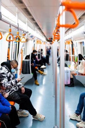 Young african american woman in medical mask using mobile phone while traveling in metro train