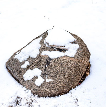 stone in the snow, closeup of photo with shallow depth of fieldの写真素材