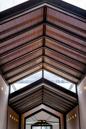 Interior of a modern building with a wooden roof and a glass ceilingの写真素材