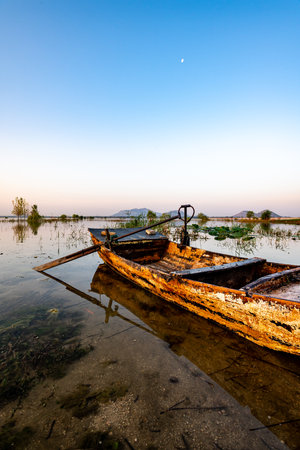 Old fishing boat on the lake at sunset, Thailand. Long exposure.の写真素材