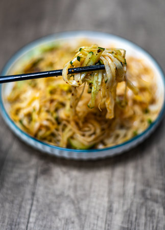 Noodles with chopsticks on a wooden background, selective focusの写真素材