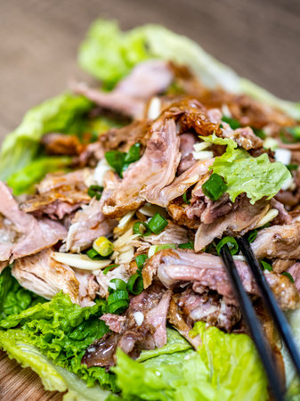 Beef salad with lettuce and green onions on a wooden background.の写真素材