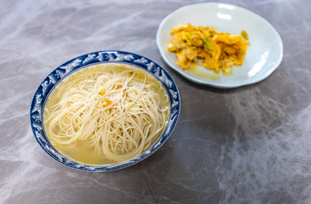 Chinese noodle soup in a bowl on the tableの写真素材