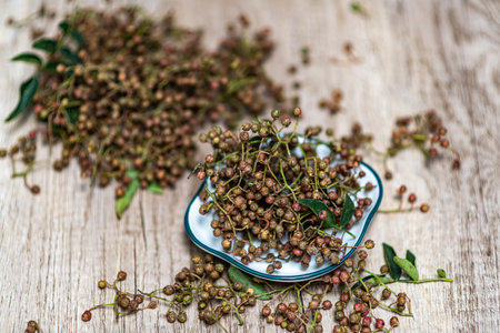 Dried thyme berries in a bowl on a wooden background.の写真素材