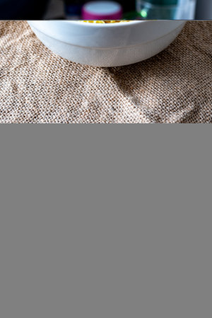 Healthy food concept. Close up of white bowl on sackclothの写真素材