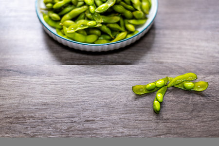 Green soybeans in bowl on wooden background, Healthy food concept.の写真素材