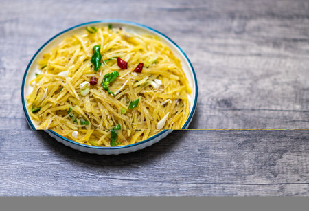 Spaghetti pasta with fresh basil and pine nuts on wooden background.の写真素材