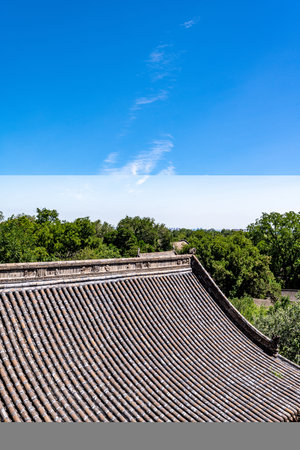 Traditional Chinese style roof tiles and blue sky in a summer day.