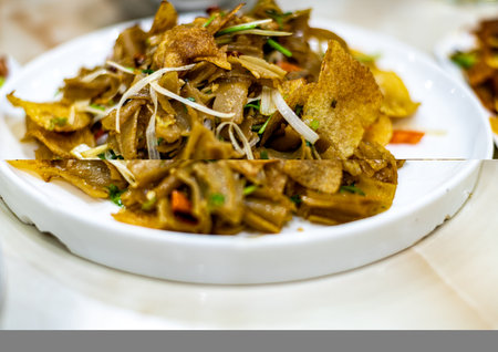 stir fried noodles in white dish on the tableの写真素材