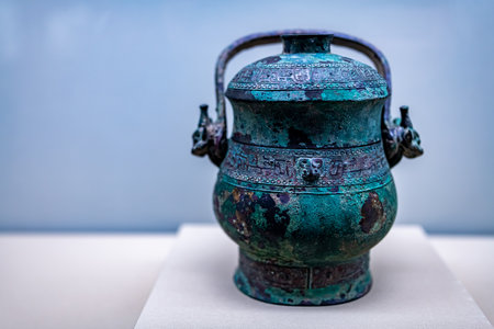 Chinese ancient bronze teapot, close-up, on blue backgroundの写真素材
