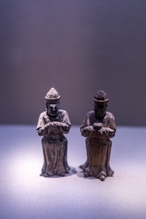 Statues of the Virgin Mary and Joseph on a dark background.
