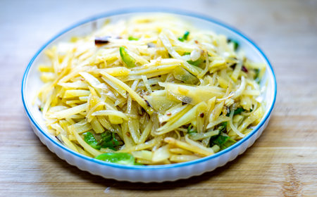 Green papaya salad in white plate on wooden table. Thai food