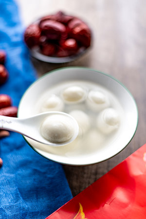 Traditional oriental sweet dumplings in a bowl on wooden backgroundの写真素材
