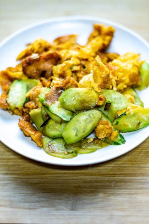 Fried zucchini with fried egg - Thai style food.の写真素材