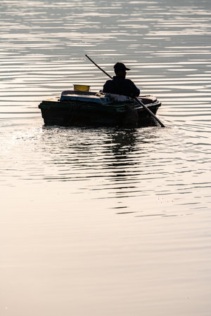 Fisherman in the boat on the lake,Thailand.