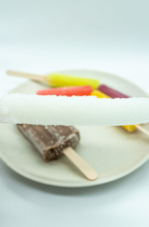 ice cream popsicles on a white plate on a white background.