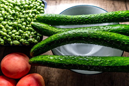 Fresh cucumbers and other vegetables on a wooden table. Selective focus.の写真素材