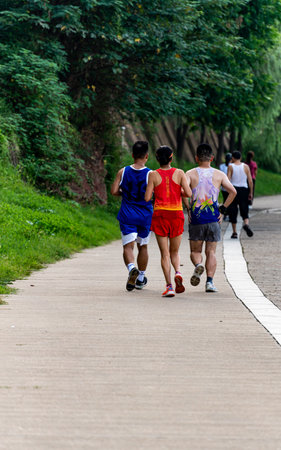 Athletes running in city parkの写真素材