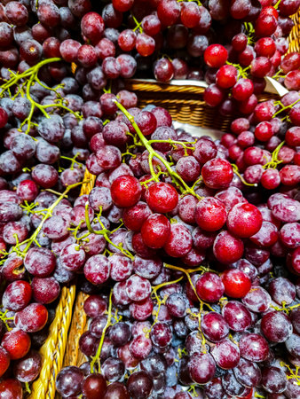 Red grapes in a basket for sale at a farmers market in Provence, Franceの写真素材
