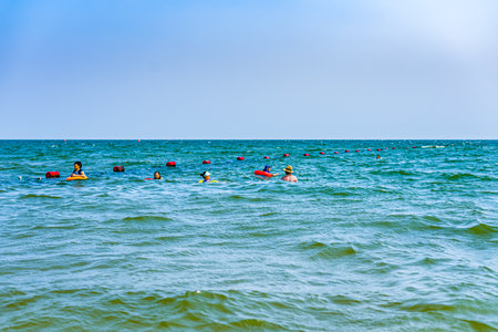 People swimming in the sea on a sunny day. Summer vacation conceptの写真素材