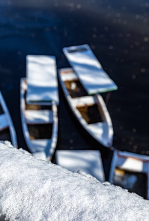 Fishing boats on the lake in winter, defocused background.の写真素材