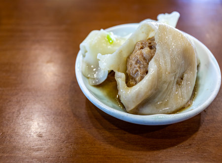 Steamed dumpling stuffed with minced pork on wooden table.の写真素材