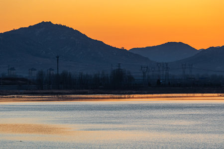 Sunset over the lake with mountains in the background, Tuscanyの写真素材