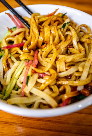 Yakisoba Noodles in a bowl on a wooden tableの写真素材