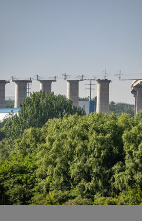 Industrial landscape with high-rise structures and green trees on a sunny day