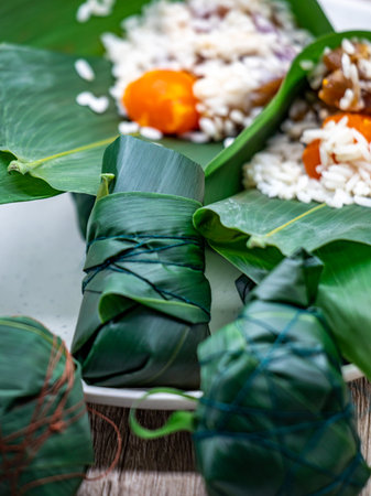 Rice dumplings with banana leaves on a wooden table.の写真素材