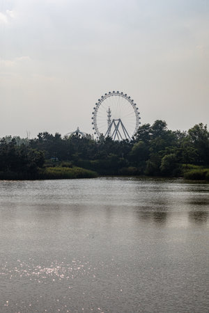 Ferris wheel in the park with reflection in the lake. Thailandのeditorial素材