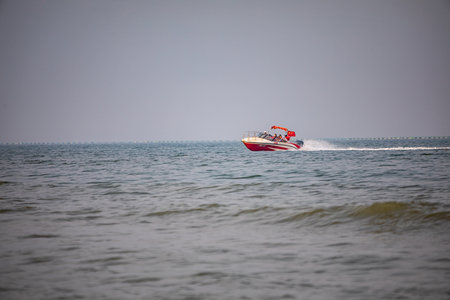 Speed boat on the sea in a cloudy day in the summer.の写真素材