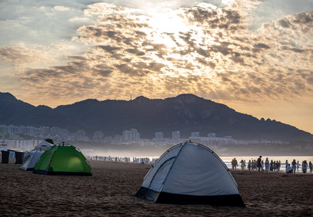 Camping tents on the beach at sunset in Hong Kong, China.の写真素材