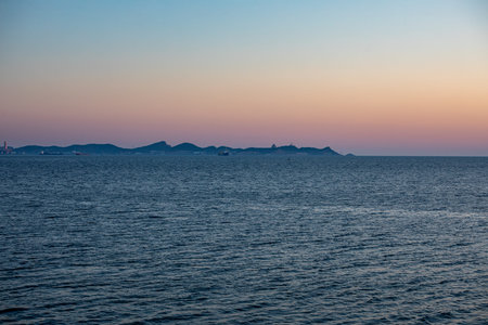 Beautiful seascape at sunset time. Dramatic sky, sea and islands.の写真素材