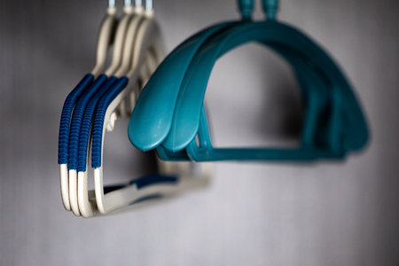 Close up view of a pair of blue hangers hanging on a wall.の写真素材