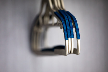 Close up view of a pair of blue plastic clothes hangers.