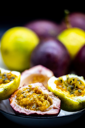 Passion fruit on black background. Passion fruit is a popular tropical fruit.の写真素材