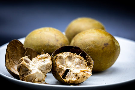 Sapodilla fruit on a white plate.