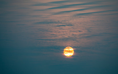 Sunset in the blue sky with clouds and sun. Sunset backgroundの写真素材