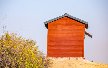 Red wooden beach hut on the sand dune in the countryside.の写真素材