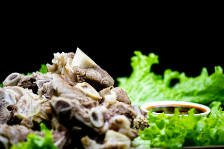 Meat stewed with vegetables on a black background. Selective focus.の写真素材