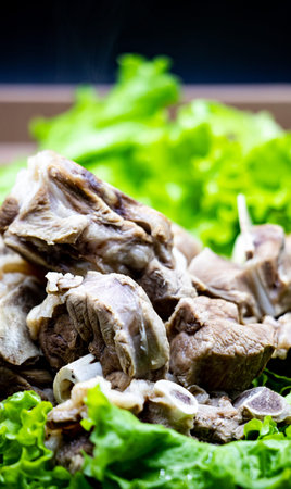 Grilled beef with fresh green salad on wooden table. Selective focus.
