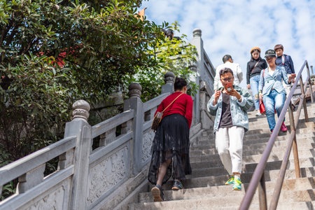 Unidentified tourists walking up the stairs to the temple in Chiang Mai, Thailand.の写真素材